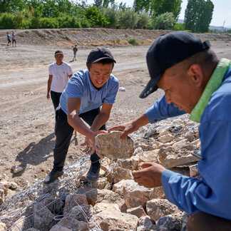 Men are carrying rocks