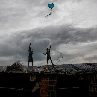 Two children flying a kite